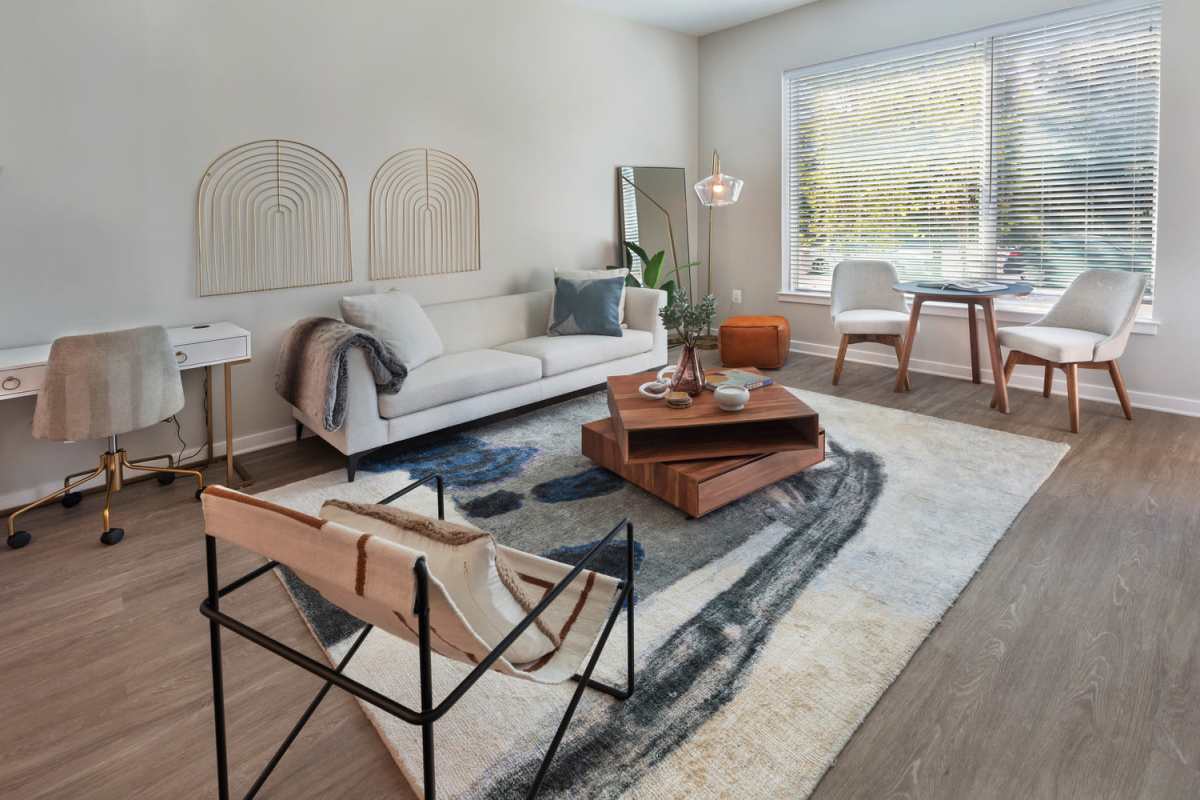 Spacious living room with couche and large window at The Blake in Alexandria, Virginia