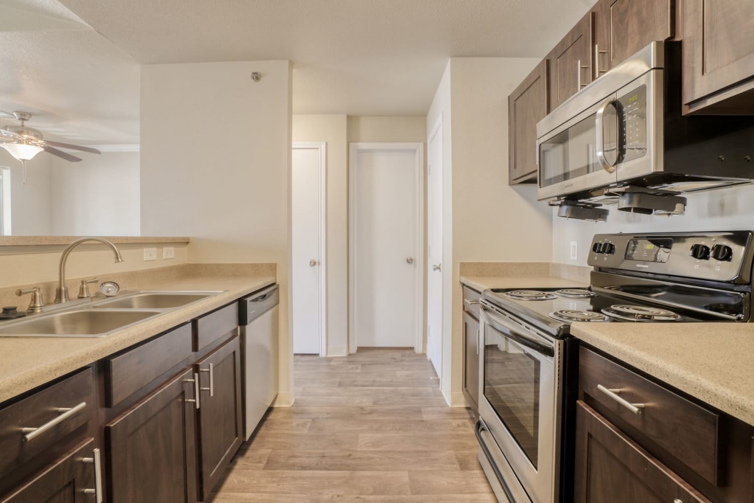 Spacious kitchen with dark counters and white cabinets at The Pines at Castle Rock Apartments in Castle Rock, Colorado