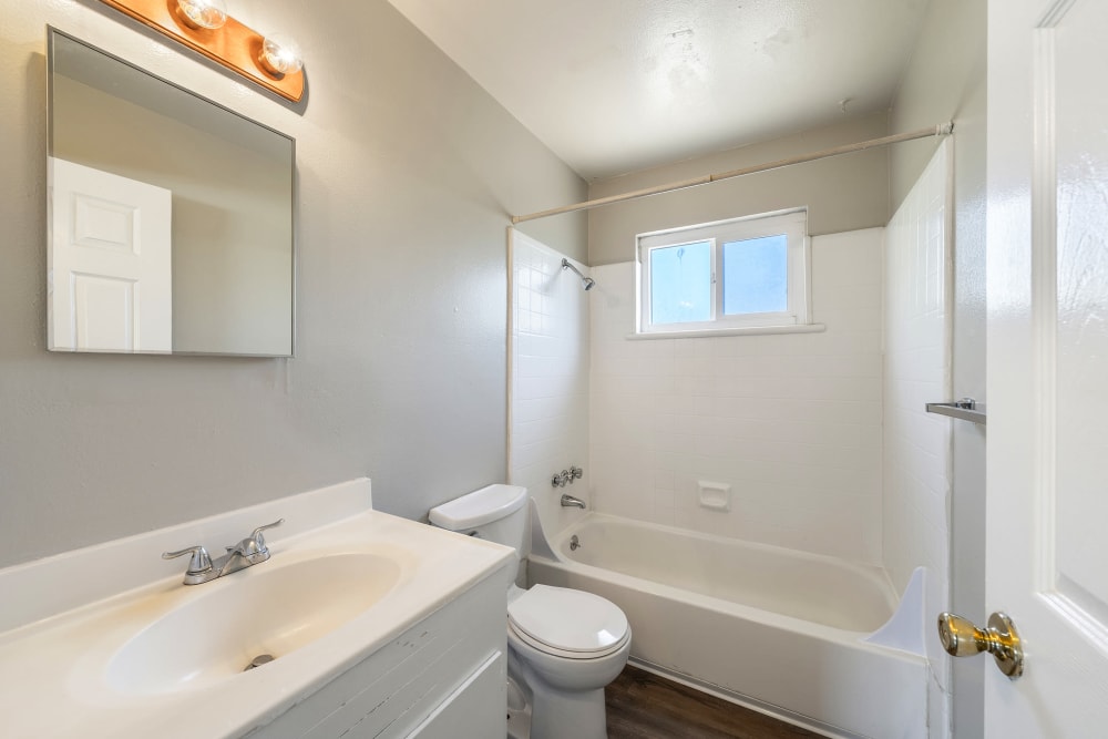 Bathroom with tub and shower at Garden Court Apartments in Alameda, California