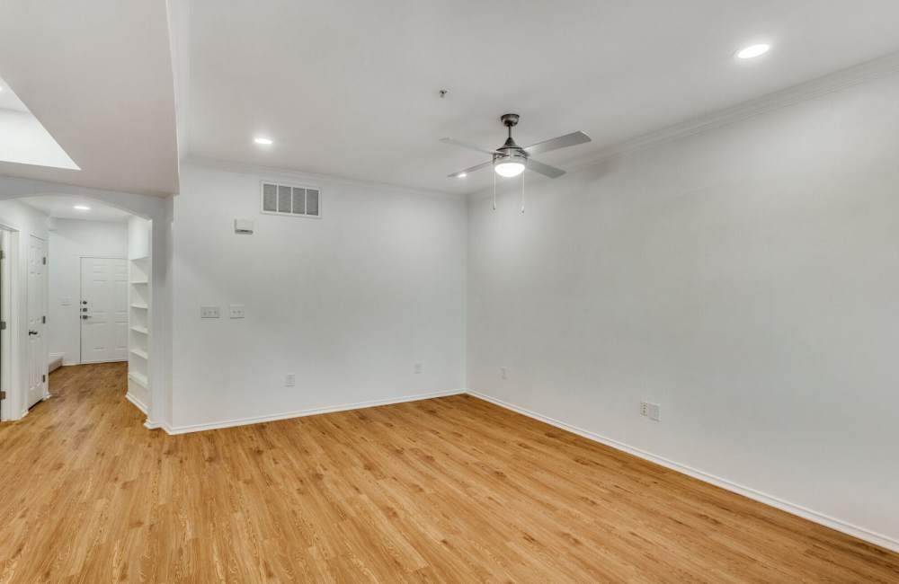 A wide angle of well-lit living room with large space for couch and lot more at Spicewood Crossing in Carrollton, Texas