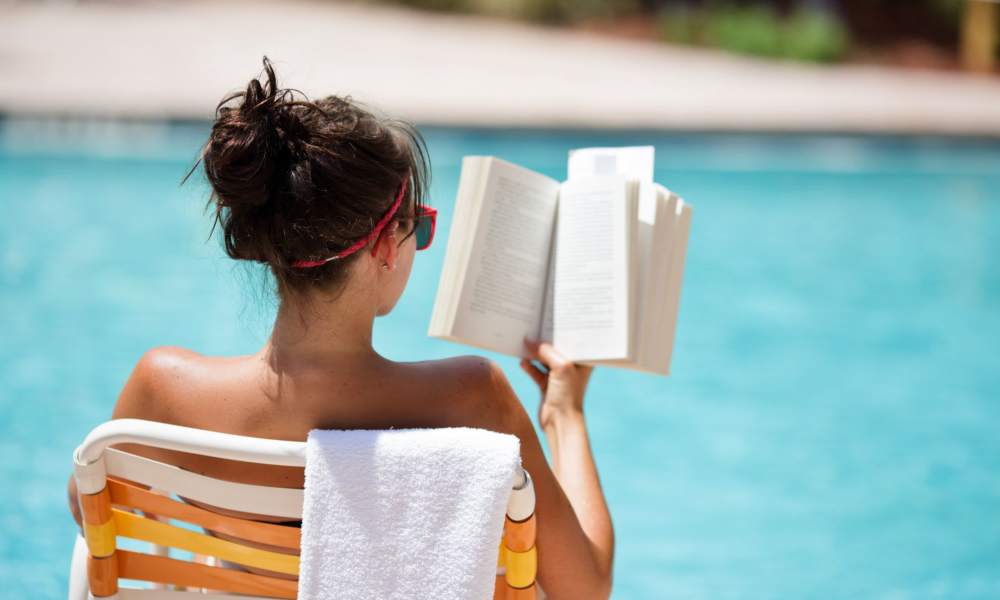 Resident reading a book on the swimming pool at Parc Marin in Corte Madera, California