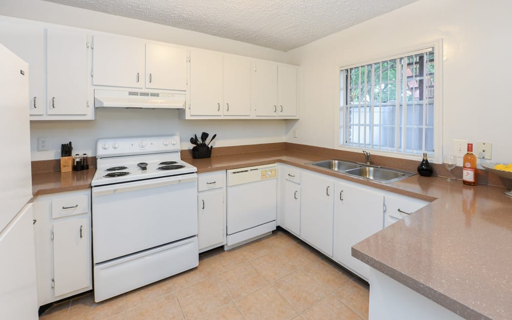 Model kitchen with white cabinetry and white appliances at Reserve at Lake Pointe Apartments & Townhomes in St Petersburg, Florida