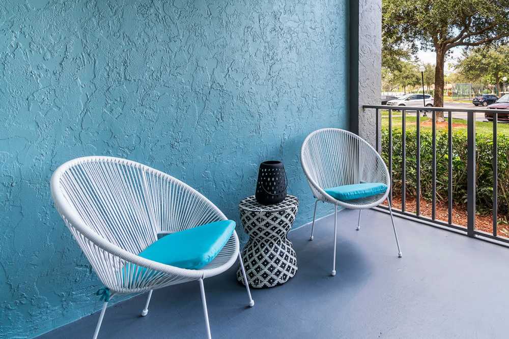 Private apartment patio with seating at Boynton Place Apartments in Boynton Beach, Florida