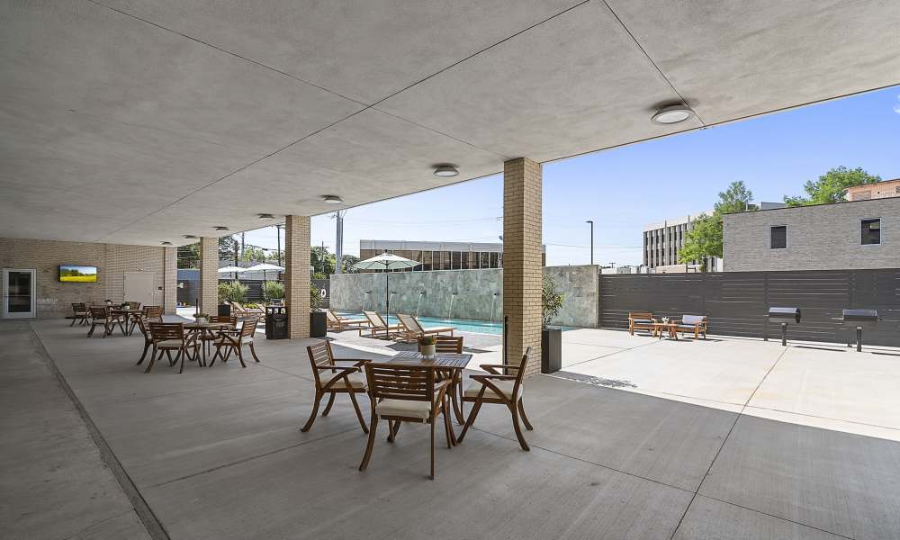 Dining area near pool at The Lofts at the Municipal in Lafayette, Louisiana