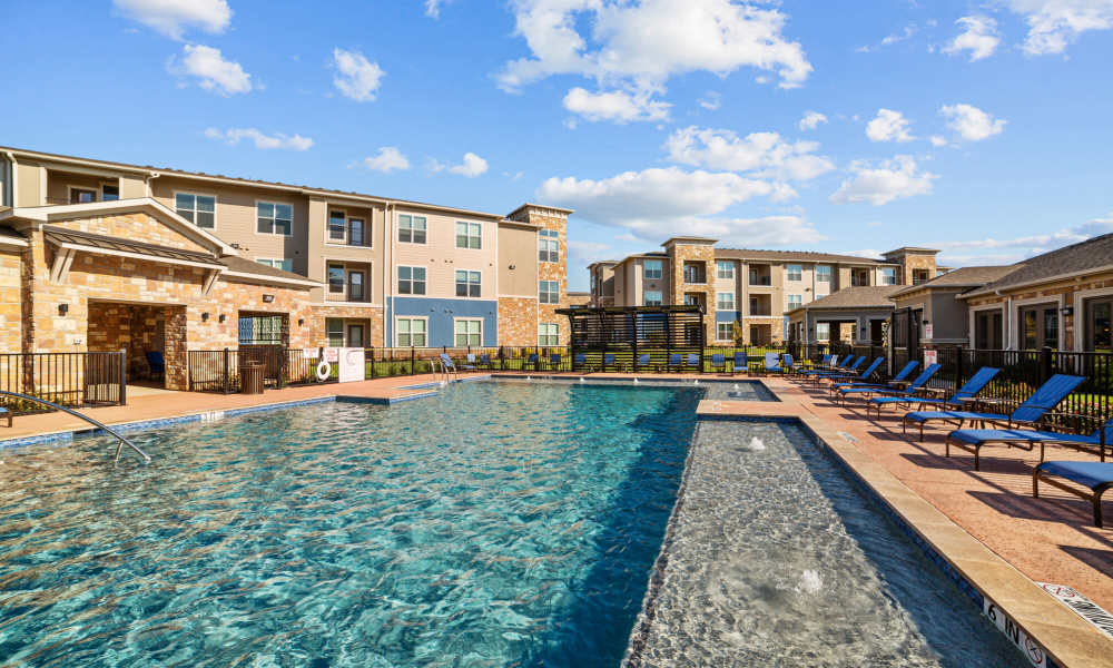 Swimming pool with lounge beds at Brook Hollow in Wichita Falls, Texas