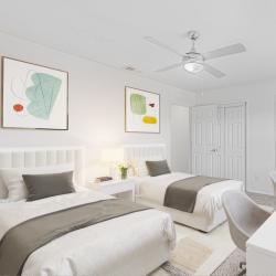Bright twin bedroom with modern decor at Crescent Place in Savannah, Georgia 