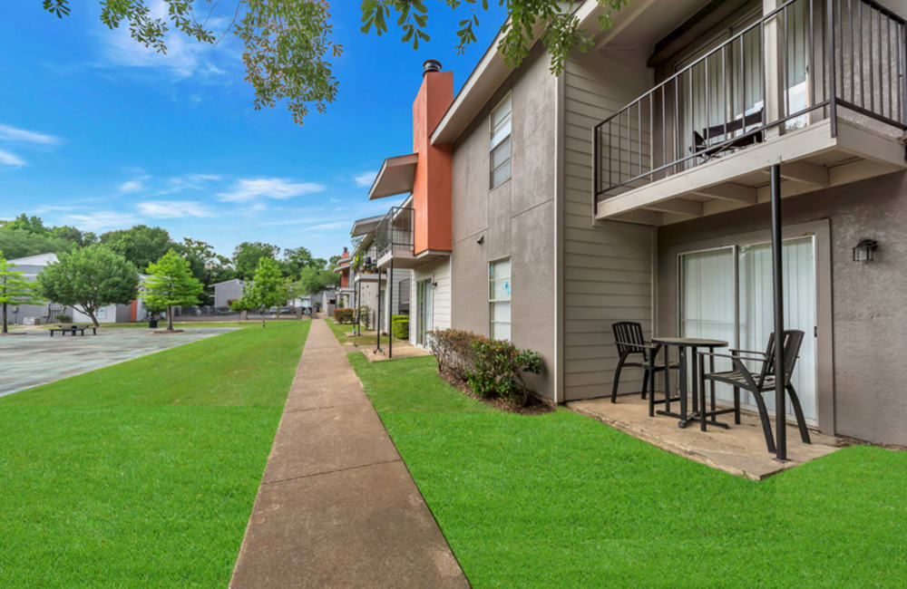 Exterior view of the building with private balconies at Oak Manor Apartments in Henderson, Texas