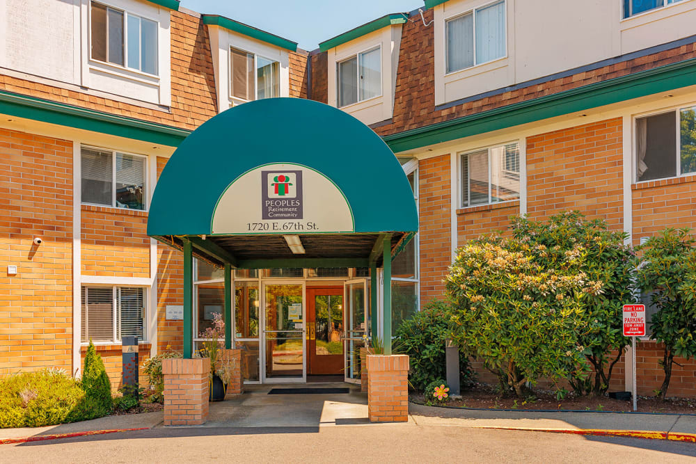 Marquis surrounded by blooming cherry blossoms at Peoples Senior Living in Tacoma, Washington