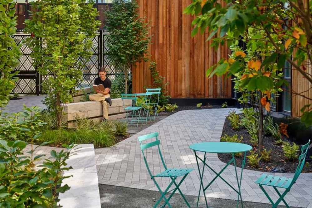 Tables and benches in the courtyard at The Cooper in Wilmington, Delaware