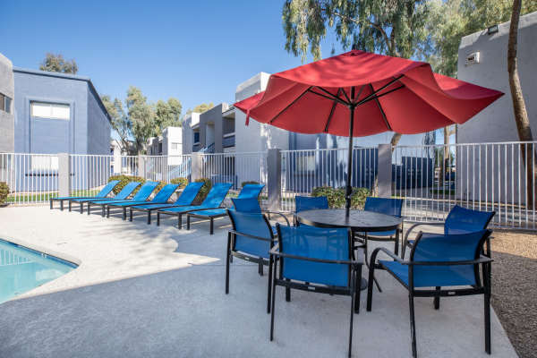 Resort-style swimming pool with lounge chairs on the deck at 544 Southern Apartments in Mesa,Arizona