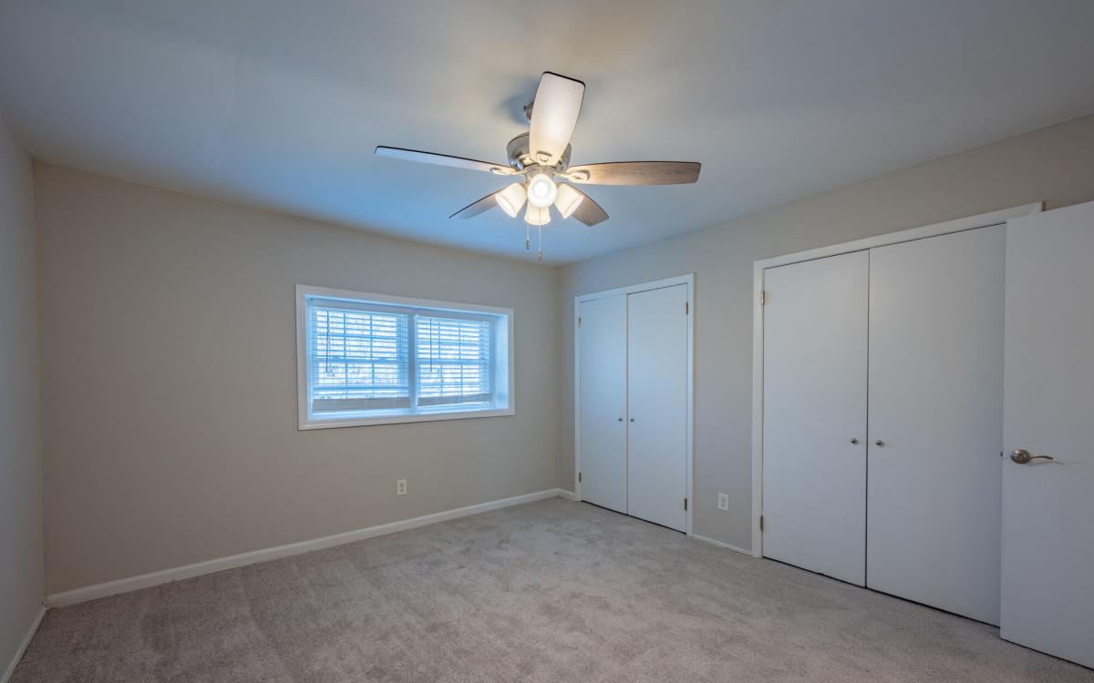 Unfurnished bedroom with celling fan at Ivey Ridge Apartments in Graham, North Carolina