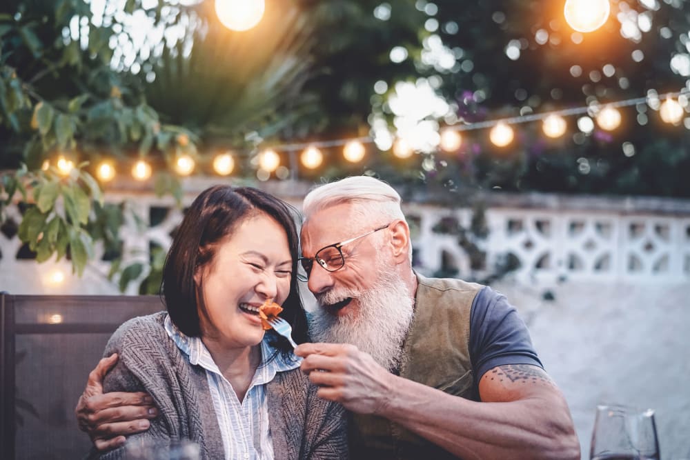 Resident couple being romantic and feeding one another at their favorite restaurant near The Preserve at Willow Park in Willow Park, Texas 