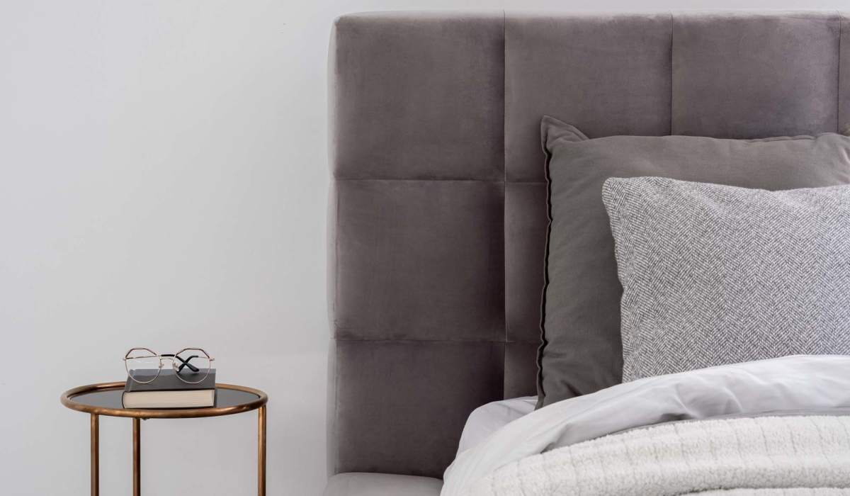 Charming bedroom with plush bedding and a sleek bedside table at Lake Pointe Apartments in Madison, Wisconsin.