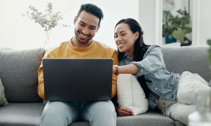 Residents using laptop in a living room at The Heights at Happy Valley in Happy Valley, Oregon