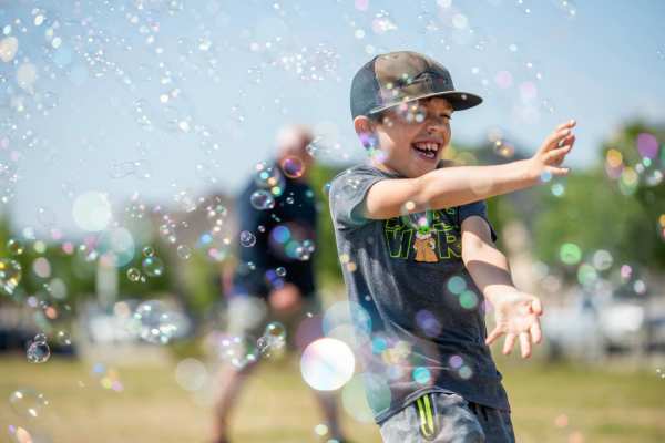 A kid playing with bubbles in the park near BB Living Wellen Park in Venice, Florida