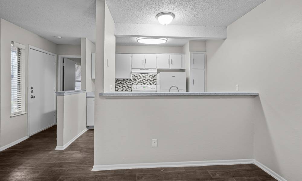 A view of pass through kitchen bar counter at Pine Oaks Apartments in Mesquite, Texas