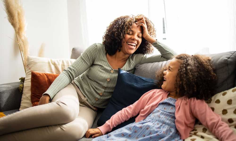 Mother and daughter in the living room at Valley Park Subdivision in Jackson, Mississippi
