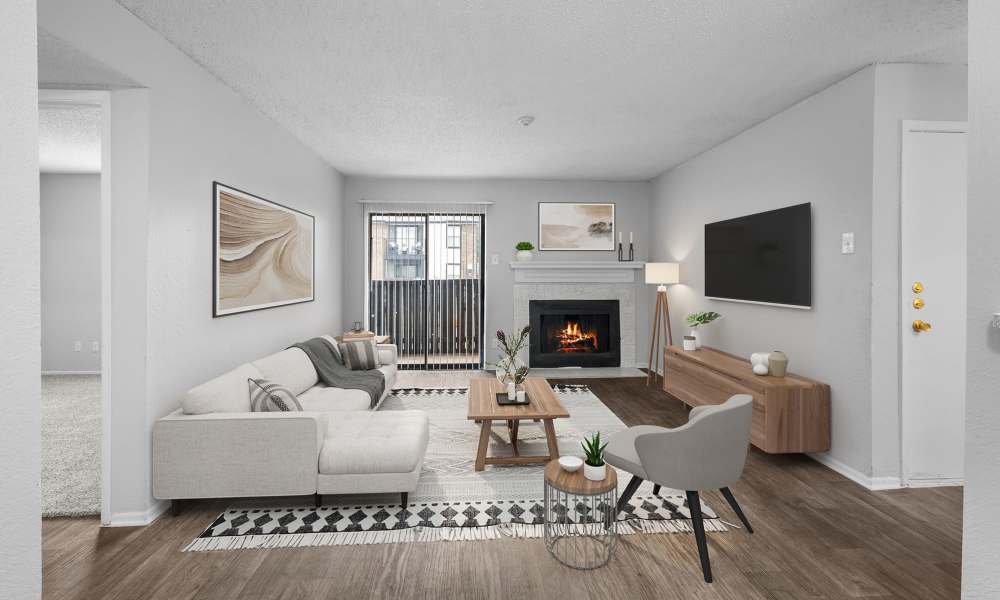 Living room with furniture at Pine Oaks Apartments in Mesquite, Texas