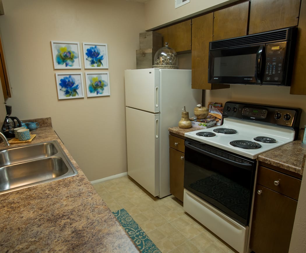 Kitchen with granite-style countertops at Barcelona Apartments in Tulsa, Oklahoma