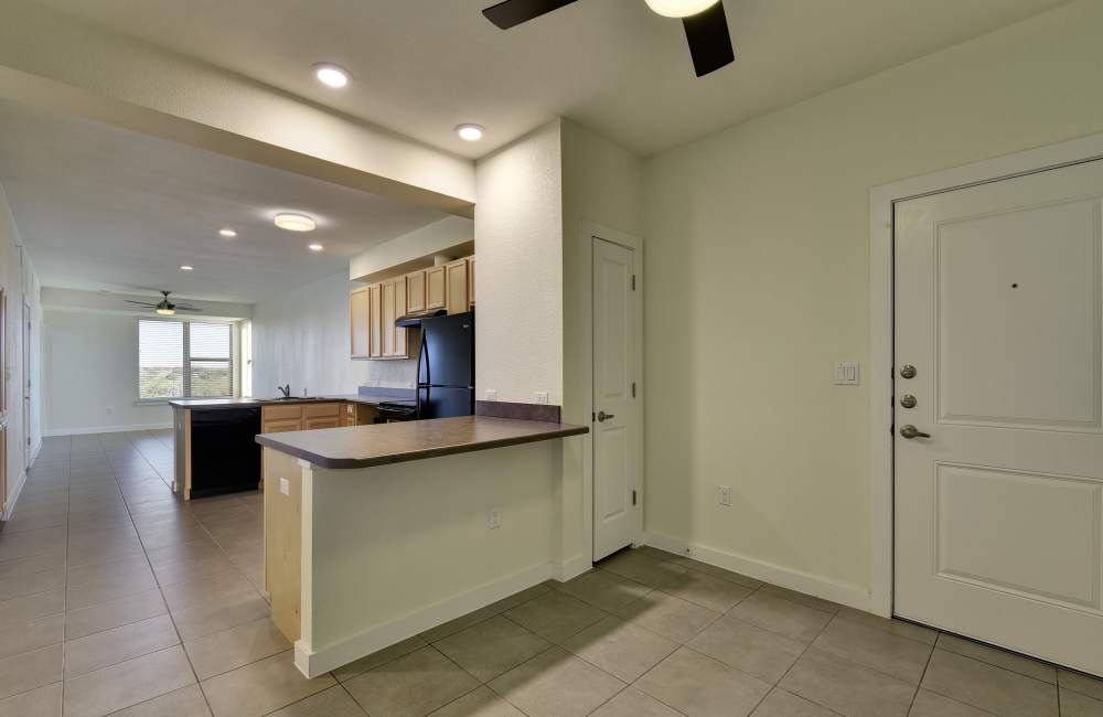 Open-concept of kitchen and living room at Homestead Oaks Apartments in Austin,Texas