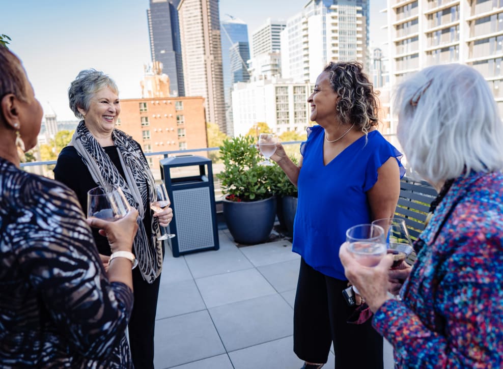 Residents outside on patio talking at Murano in Seattle, Washington