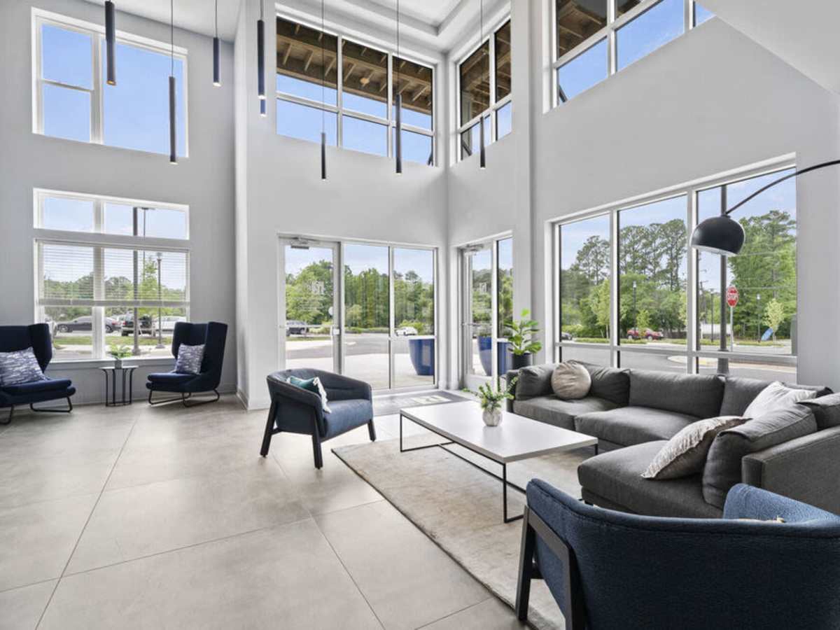 Lounge area with lots of seating and large glass windows at The Rise at Regency in Henrico, Virginia