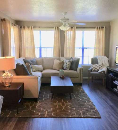 Spacious living room with seating spaces at The Reserve at Kanapaha in Gainesville, Florida