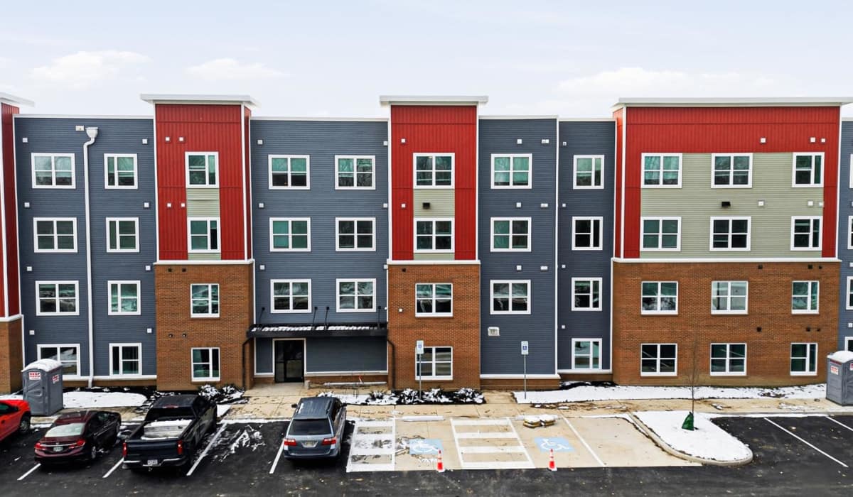 A wide exterior view of the apartment building at Granville Woods Lofts II in Columbus, Ohio