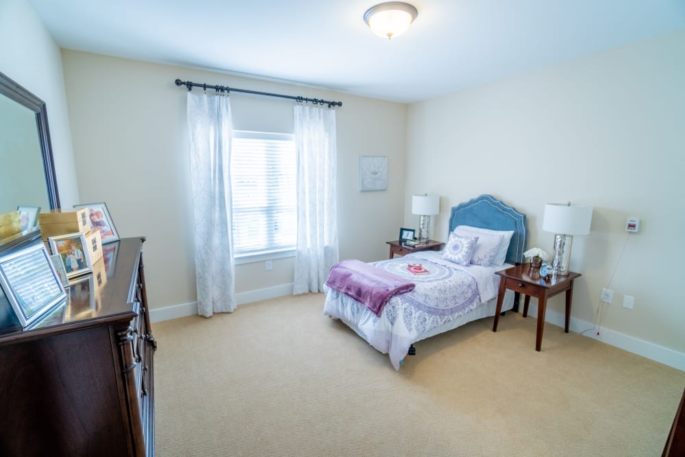 Private bedroom with bend and dresser at Harmony at Anderson in Cincinnati, Ohio