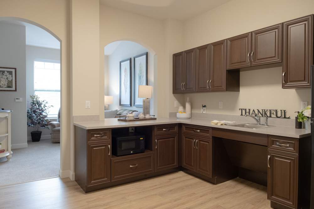 Kitchen with stainless-steel sink, oven and access to living room at Harmony at White Oaks in Bridgeport, West Virginia