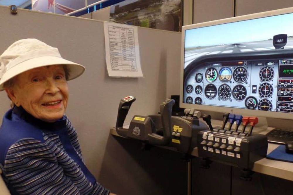 Playig on a flight simulator at Roseville Commons Senior Living in Roseville, California