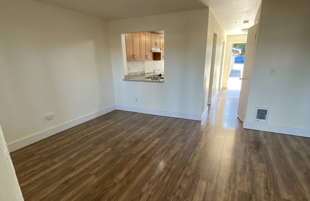 Living room with wood-style floors at Evergreen Townhomes