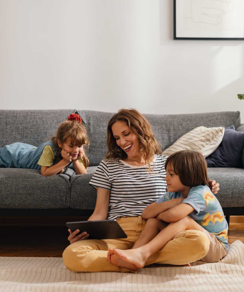 Resident with her kids in the modern living area at 440 on Third Apartments in Baton Rouge, Louisiana