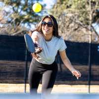 Resident  playing pickleball outdoors at Athena Apartments in Benbrook, Texas