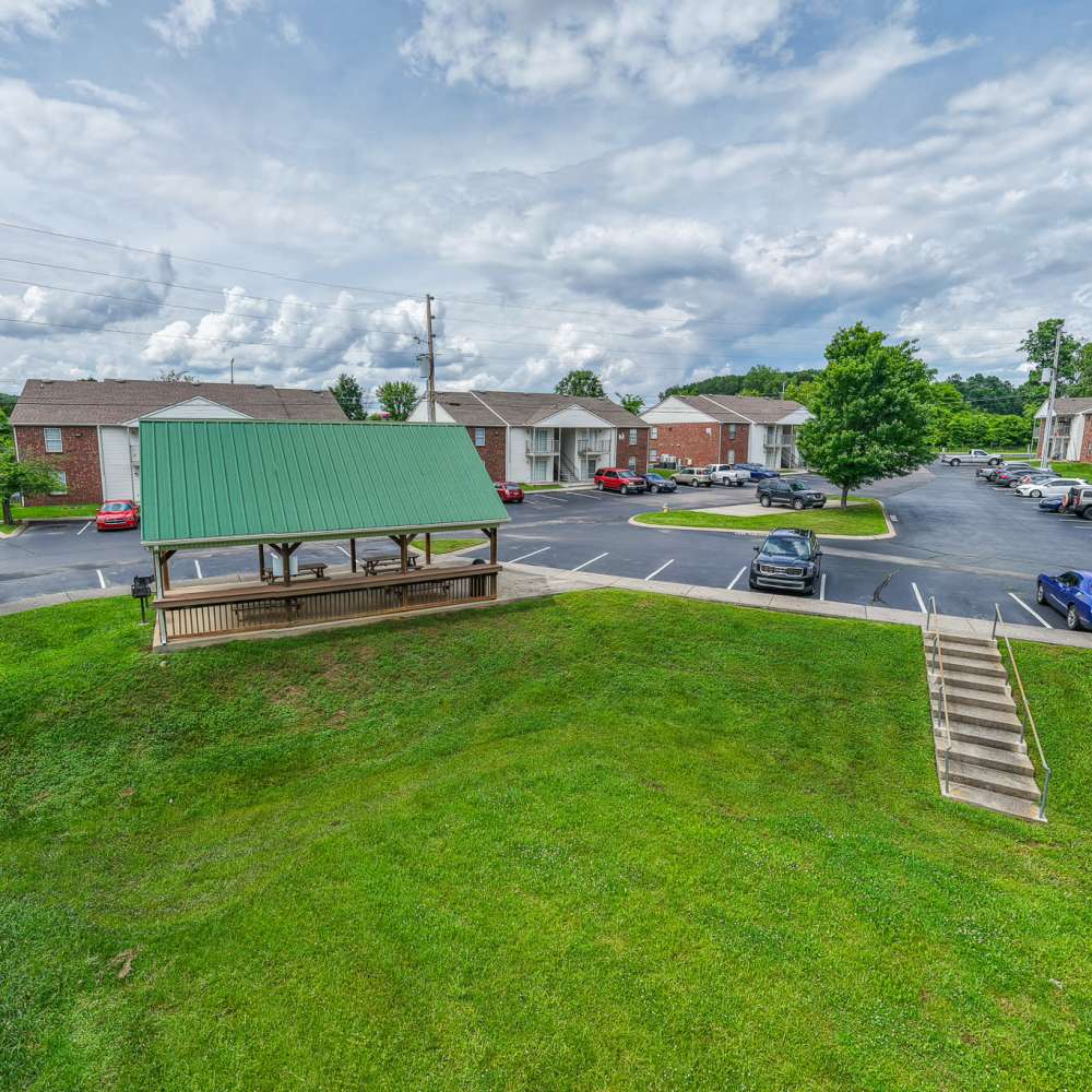 Exterior view of the community with green lawn Village Crest Apartment Homes in Smyrna, Tennessee