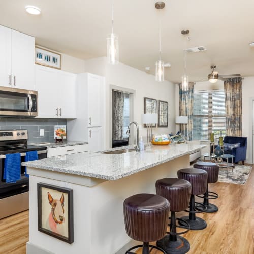 Furnished apartment with wood-style flooring at The Grand At Saginaw in Saginaw, Texas