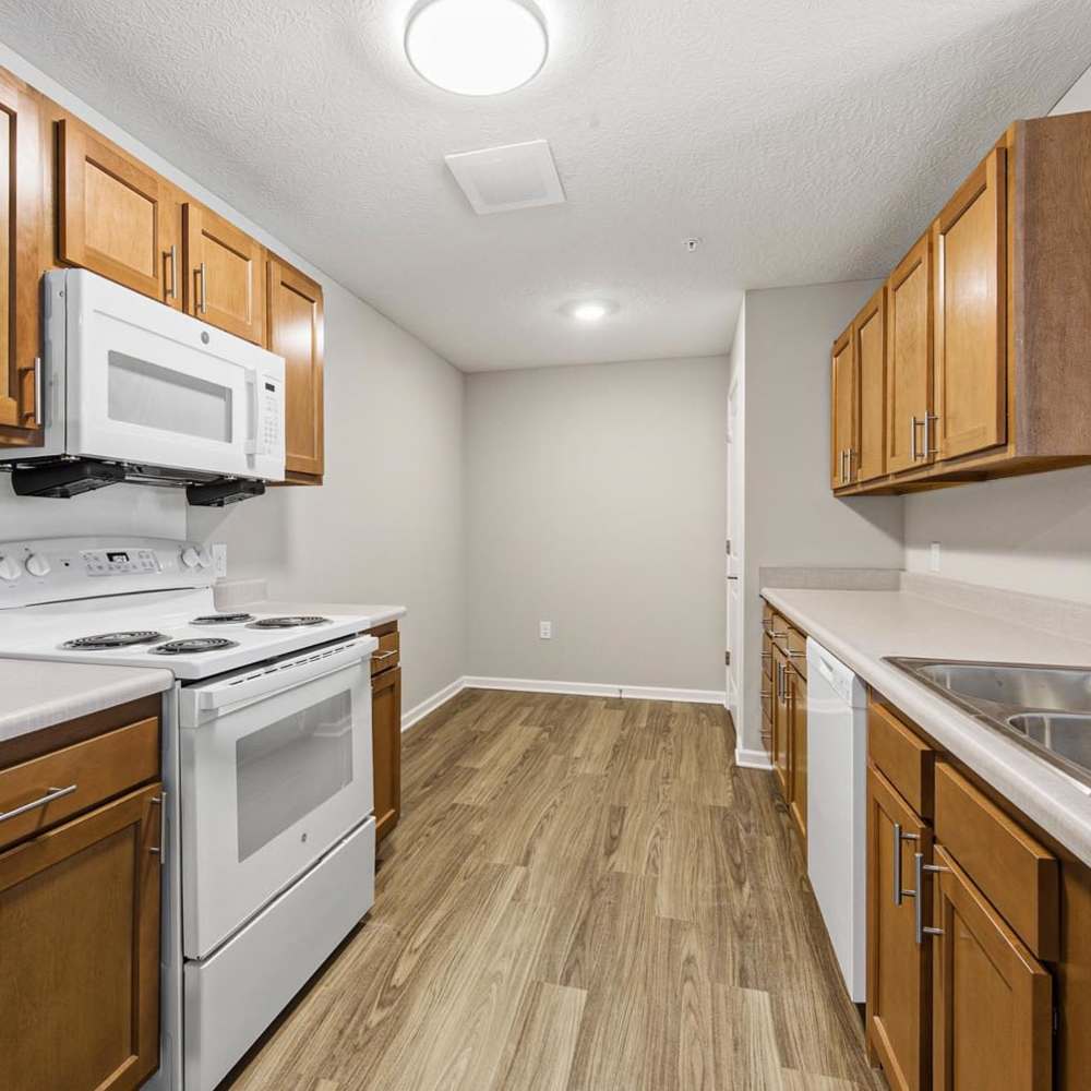 A sleek modern kitchen with white appliances at Granville Woods Lofts II in Columbus, Ohio