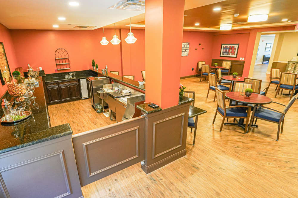 Waiting hall with multiple tables and chairs at Harmony at Harts Run in Glenshaw, Pennsylvania