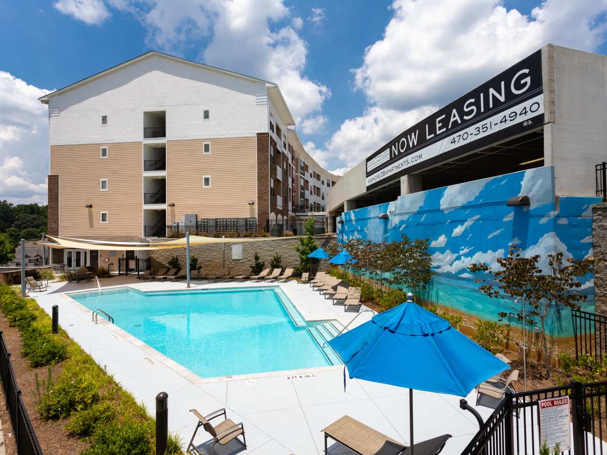 Poolside chairs and umbrellas by the modern pool at Ardmore & Twenty Eighth in Atlanta, Georgia