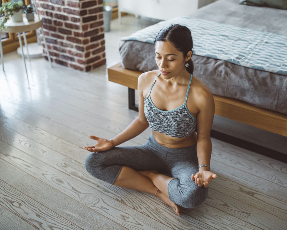 Resident meditating in her bedroom at Live on 4th in Cincinnati, Ohio