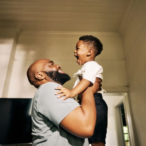 Resident playing with his kid at Silo Creek Apartments in Lafayette, Louisiana
