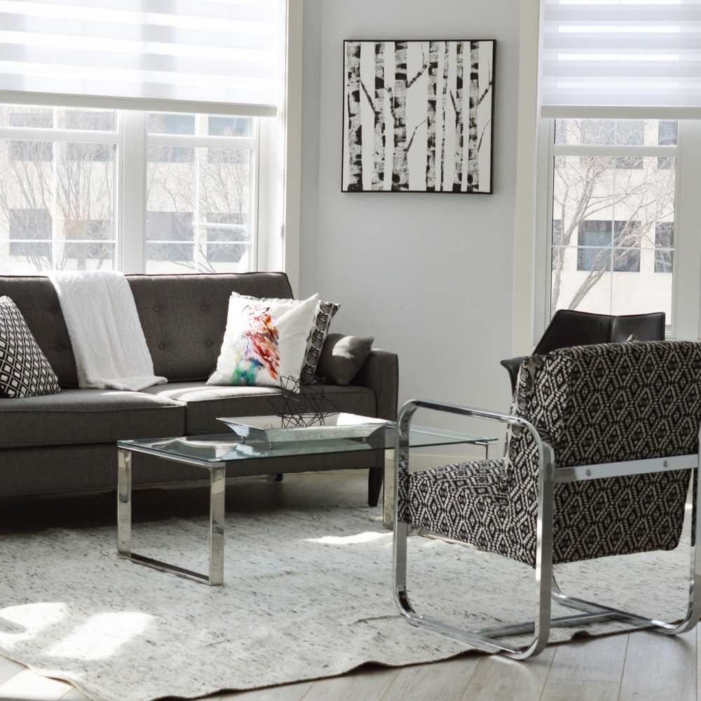 Living room with center table and large window at Cross Timbers At Grand Street in Amarillo, Texas