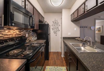 Modern kitchen with beautiful wood cabinets at Trails of Towne Lake in Irving, Texas