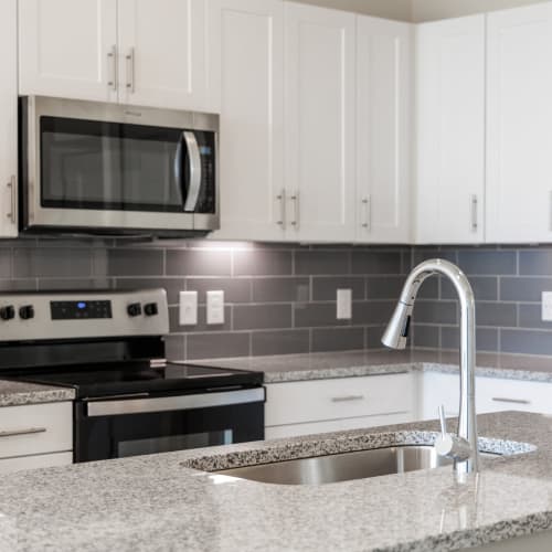 Kitchen with stainless-steel appliances at The Grand At Saginaw in Saginaw, Texas