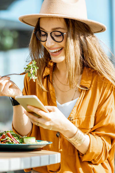 Resident eating a salad at a local restaurant in Allen, Texas near Magnolia on the Green