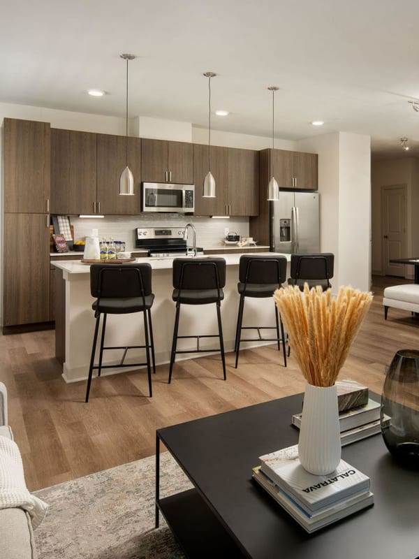 Elegant open floor plan between living-room and kitchen with hardwood floors at Las Palmas in Fort Myers, Florida