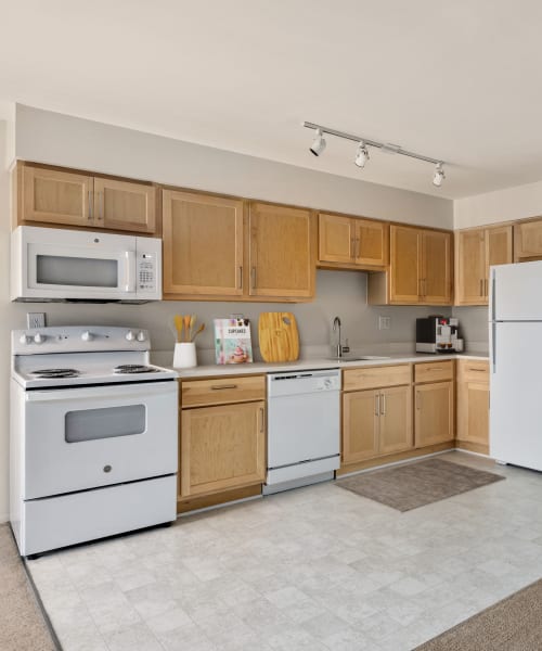 Kitchen with a dishwasher and built-in microwave at Farmington Oaks Apartments in Farmington, Michigan