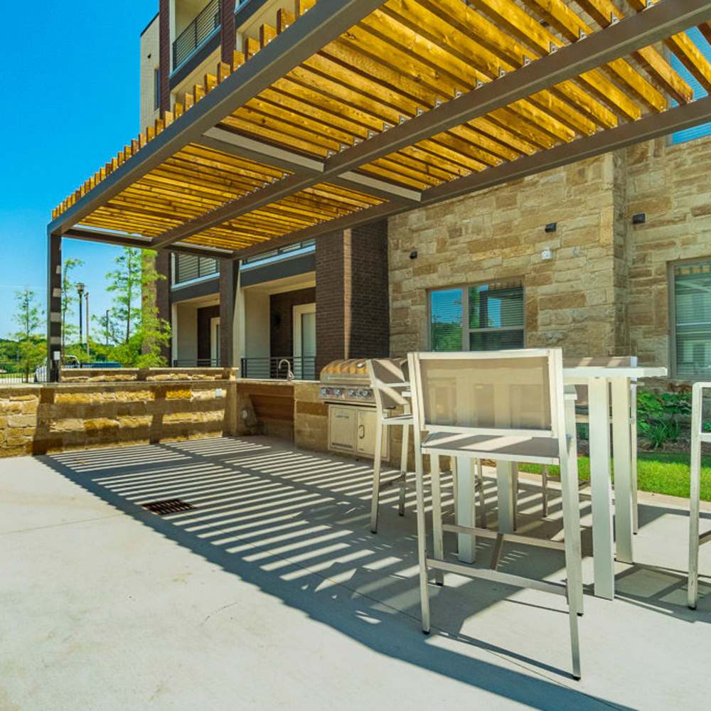Outdoor barbeque area at Millennium Place in Corinth, Texas