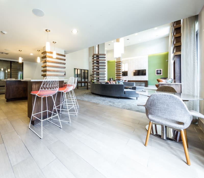 Kitchen island with tall counter chairs in community clubhouse at Marq Uptown in Austin, Texas