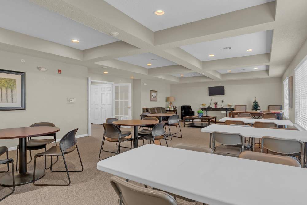 Community dining room with table and chair at Hartford Villas in Broken Arrow, Oklahoma